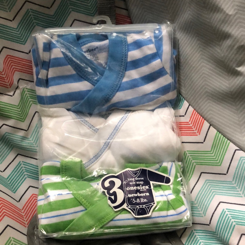 A three pack long sleeve onesies new born